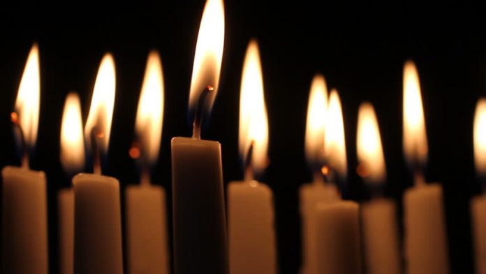 group-of-dimly-lit-burning-white-candles-create-mood-ambiance-picture-of-a-lit-candle
