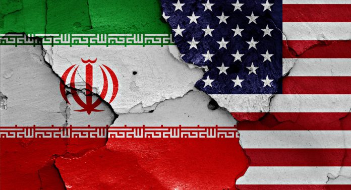 flags of Iran and USA painted on cracked wall